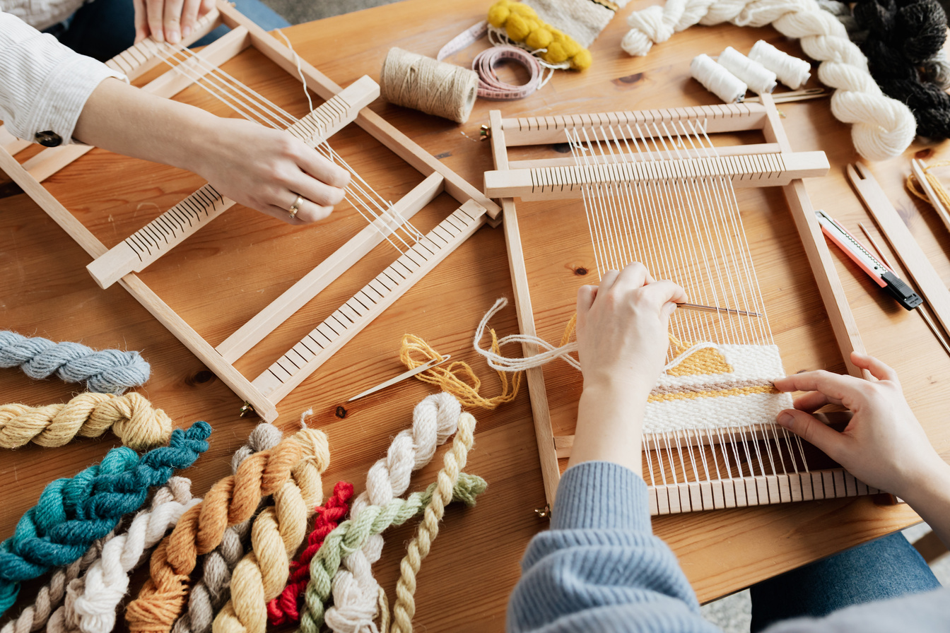 Photo of Two Person's Hands Weaving